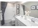 Bright bathroom with double vanity, framed mirror and shower-tub combination at 1044 Country Pasture Cv, Wendell, NC 27591