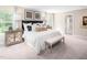 Spacious bedroom features a king bed, neutral tones, and plenty of natural light creating a tranquil retreat at 1044 Country Pasture Cv, Wendell, NC 27591
