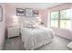 Charming pink bedroom features a cozy bed, decorative pillows, and soft lighting creating a peaceful retreat at 1044 Country Pasture Cv, Wendell, NC 27591