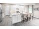 Bright kitchen features a large center island with barstool seating, stainless steel appliances, and ample storage at 1044 Country Pasture Cv, Wendell, NC 27591