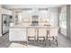 Bright kitchen features a large center island with barstool seating, stainless steel appliances, and ample storage at 1044 Country Pasture Cv, Wendell, NC 27591