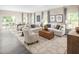 Spacious open-concept living room adjacent to dining, with plush seating, stylish decor, and great natural light at 1044 Country Pasture Cv, Wendell, NC 27591