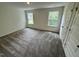 Spacious bedroom with plush carpeting and plenty of natural light at 10527 Brookside Reserve Rd, Raleigh, NC 27614