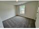 Cozy bedroom with large window and plush carpeting at 10527 Brookside Reserve Rd, Raleigh, NC 27614