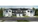 Charming townhomes with white and blue exteriors, complemented by well-manicured lawns and driveways at 10527 Brookside Reserve Rd, Raleigh, NC 27614