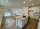 Open-concept kitchen with granite countertops, stainless steel appliances, and hardwood floors at 10527 Brookside Reserve Rd, Raleigh, NC 27614