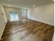 Bright living area with hardwood floors and sliding glass doors at 10527 Brookside Reserve Rd, Raleigh, NC 27614