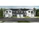 New construction townhomes with white siding, garage, and covered entryways at 10542 Brookside Reserve St, Raleigh, NC 27614