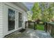Inviting back porch features double glass doors and a wooden railing, perfect for enjoying outdoor living at 107 Piquot Dr, Louisburg, NC 27549