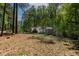 Backyard featuring lush greenery, a small shed, and well-maintained surroundings, perfect for outdoor enjoyment at 107 Piquot Dr, Louisburg, NC 27549