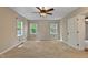 Neutral bedroom showcasing carpet, two windows, a ceiling fan and plenty of natural light at 107 Piquot Dr, Louisburg, NC 27549