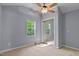 Cozy bedroom boasts a ceiling fan, ample natural light, and closet with mirrored doors at 107 Piquot Dr, Louisburg, NC 27549