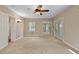 Neutral bedroom featuring a ceiling fan, windows and sliding glass doors to the outside at 107 Piquot Dr, Louisburg, NC 27549