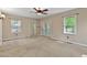 Neutral bedroom featuring carpet, two windows, sliding mirrored closet doors and French doors at 107 Piquot Dr, Louisburg, NC 27549