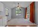Open dining area with vaulted ceilings, large windows, and stylish ceiling fan, ideal for Gathering meals at 107 Piquot Dr, Louisburg, NC 27549