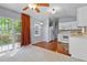 Bright eat-in kitchen area with hardwood floors and adjacent all-white kitchen at 107 Piquot Dr, Louisburg, NC 27549