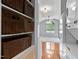Hallway with storage, leading to a sunlit living space with a laundry area and large window at 107 Piquot Dr, Louisburg, NC 27549