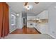 The kitchen features white cabinets, a mosaic backsplash, stainless appliances, and hardwood floors at 107 Piquot Dr, Louisburg, NC 27549