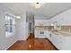 Kitchen features a window and hardwood flooring at 107 Piquot Dr, Louisburg, NC 27549