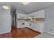 Well-lit kitchen boasts white cabinets, efficient appliances, and stylish accents for a functional and attractive space at 107 Piquot Dr, Louisburg, NC 27549