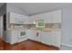 Bright kitchen features white cabinetry, tile backsplash, and modern appliances, perfect for cooking and entertaining at 107 Piquot Dr, Louisburg, NC 27549