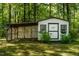Shed with latticed porch offers ample space for storage or hobbies amidst a tranquil setting at 107 Piquot Dr, Louisburg, NC 27549