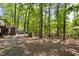 Spacious backyard with a deck, hot tub, and lush trees at 109 Bessemer Pl, Durham, NC 27712