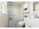 Bright bathroom featuring a glass-enclosed shower, storage cabinets, and sleek fixtures for a clean look at 109 Bessemer Pl, Durham, NC 27712