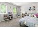 Bright bedroom featuring soft carpet, themed decorations, and plenty of natural light, creating a joyful space at 109 Bessemer Pl, Durham, NC 27712