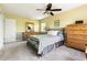 Well-lit bedroom features soft carpeting, a ceiling fan, and coordinated furnishings for a comfortable retreat at 109 Bessemer Pl, Durham, NC 27712