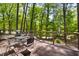 Outdoor deck area featuring an outdoor dining set and lush greenery views at 109 Bessemer Pl, Durham, NC 27712