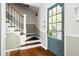 Welcoming entryway featuring hardwood floors, stairs, and a glass-paneled front door at 109 Bessemer Pl, Durham, NC 27712
