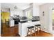 Modern kitchen with white cabinets, black countertops, and a breakfast bar area at 109 Bessemer Pl, Durham, NC 27712