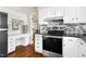 Bright kitchen with stainless steel oven, granite countertops, stylish tile backsplash, and integrated desk area at 109 Bessemer Pl, Durham, NC 27712