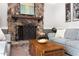 Cozy living room showcasing a beautiful stone fireplace and comfortable seating arrangement with natural light at 109 Bessemer Pl, Durham, NC 27712