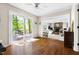 Open floor plan featuring hardwood floors, sliding glass doors to the deck, and an open view of the stone fireplace at 109 Bessemer Pl, Durham, NC 27712
