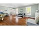 Bright living room with hardwood floors, large windows, and a comfortable seating area at 109 Bessemer Pl, Durham, NC 27712