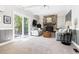 Cozy living room with stone fireplace, and sliding glass doors leading to the outdoor deck area at 109 Bessemer Pl, Durham, NC 27712