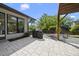 The outdoor patio features stone tiling, a modern grill, and backyard greenery with a glimpse of a pergola at 1101 Norris St, Raleigh, NC 27604