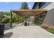 Outdoor patio featuring a dining table under a pergola, on stone tiles with greenery surrounding the space at 1101 Norris St, Raleigh, NC 27604