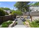 Backyard with a seating area, landscaping, a stone fire pit, gravel hardscape, and a basketball hoop at 1101 Norris St, Raleigh, NC 27604