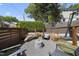 Backyard featuring a seating area, landscaping, a stone fire pit, gravel hardscape, and a basketball hoop at 1101 Norris St, Raleigh, NC 27604