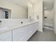 Modern bathroom with double sink vanity, quartz countertop, and glass-enclosed shower at 1101 Norris St, Raleigh, NC 27604