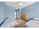 Bedroom features hardwood floor, two twin beds, large window, ceiling fan and blue walls at 1101 Norris St, Raleigh, NC 27604