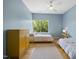 Bedroom features two twin beds, hardwood floors, large windows, and closet space at 1101 Norris St, Raleigh, NC 27604
