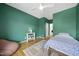 Bright bedroom features a green wall, hardwood floors, area rug, and natural light at 1101 Norris St, Raleigh, NC 27604