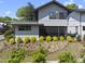 Charming two-story home with grey siding, complemented by well-maintained landscaping at 1101 Norris St, Raleigh, NC 27604