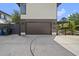 View of a two car garage and concrete driveway with a fenced in yard to the side at 1101 Norris St, Raleigh, NC 27604