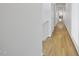 Long hallway has hardwood floors and neutral paint, ready to welcome new residents and guests at 1101 Norris St, Raleigh, NC 27604