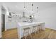 Modern kitchen featuring a large island, stainless steel appliances, and light wood floors at 1101 Norris St, Raleigh, NC 27604